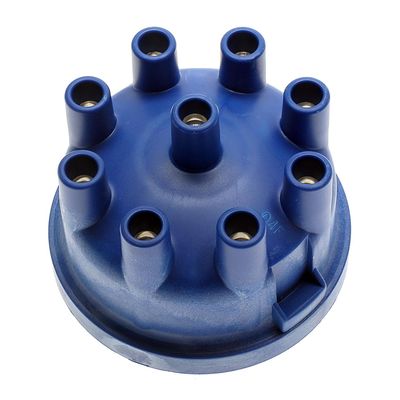 What is the benefit of using high dielectric strength materials in the distributor cap?